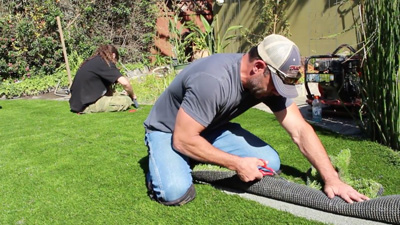 Artificial grass installation made easy with this video of a landscape turf installer.
