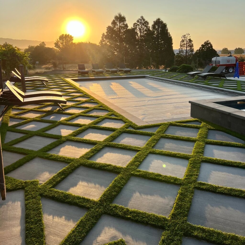 Evernatural Classic artificial grass with pavers at sunset by Guys Yard Designs