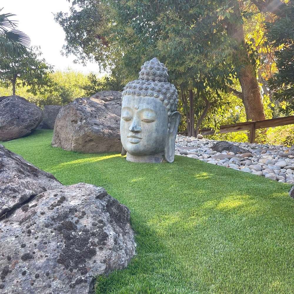 Evernatural Premium artificial turf with buddha sculpture
